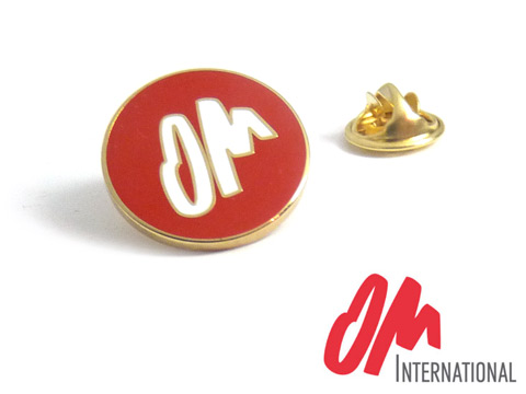 OM custom gold plated metal and red and white enamel badges.